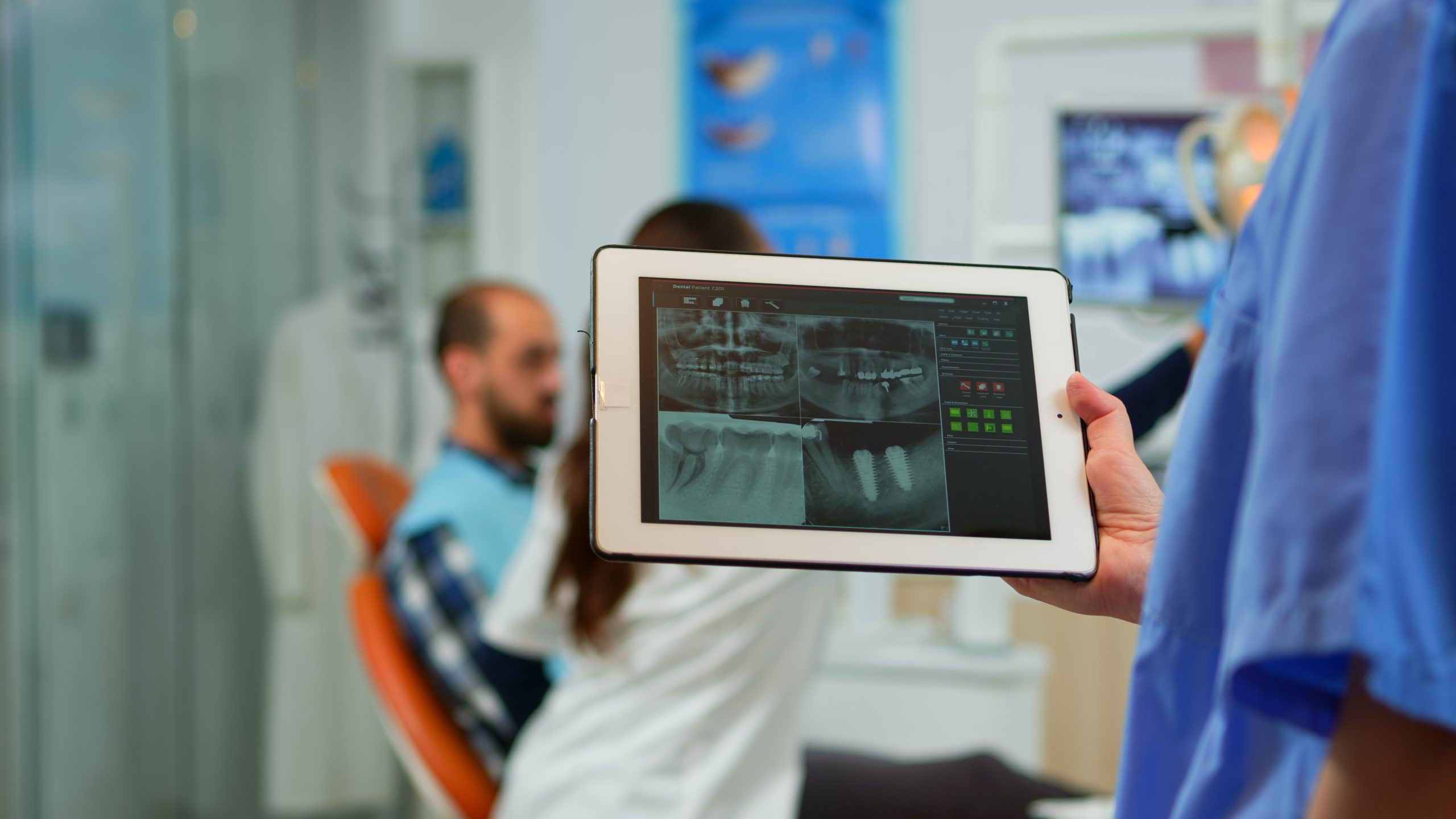 Close up dentist nurse holding tablet with digital radiography